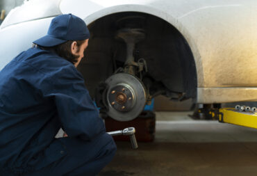 male-car-mechanic-working-car-repair-shop