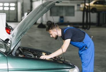 technician-fixing-car-engine-garage