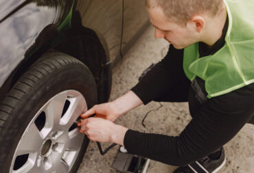 Man changing wheel after a car breakdown. Transportation, traveling concept.