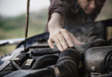 Man try to fix a car engine problem on a local road Chiang mai Thailand - people with car problem transportation concept